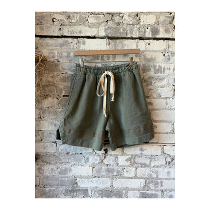 Men's heavyweight gym class shorts in pond green by MONOSTERO, displayed on a model with a relaxed fit and athletic style.