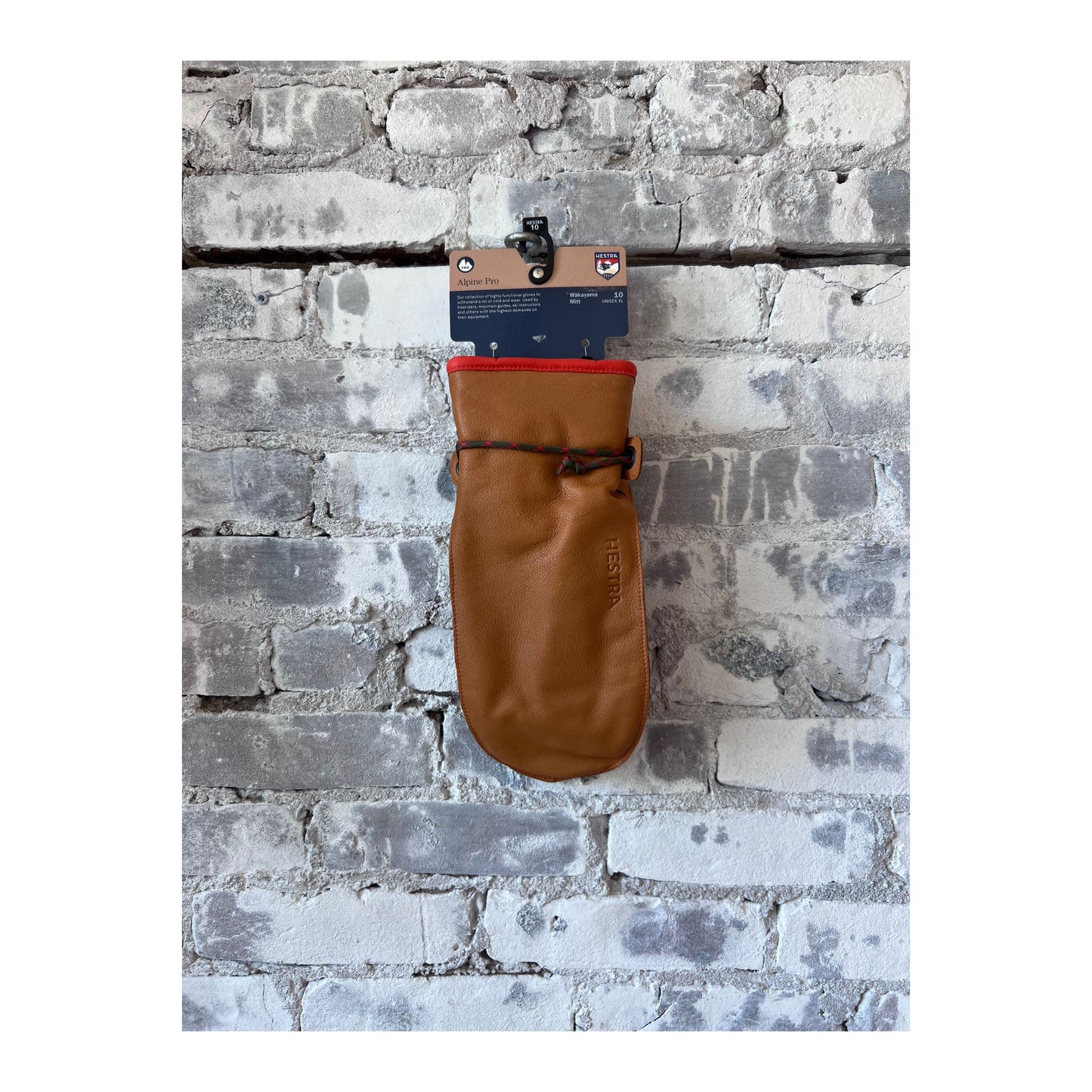 Men's Hestra Wakayama Mitt in cork and brown leather, showing the textured exterior and cozy interior lining.