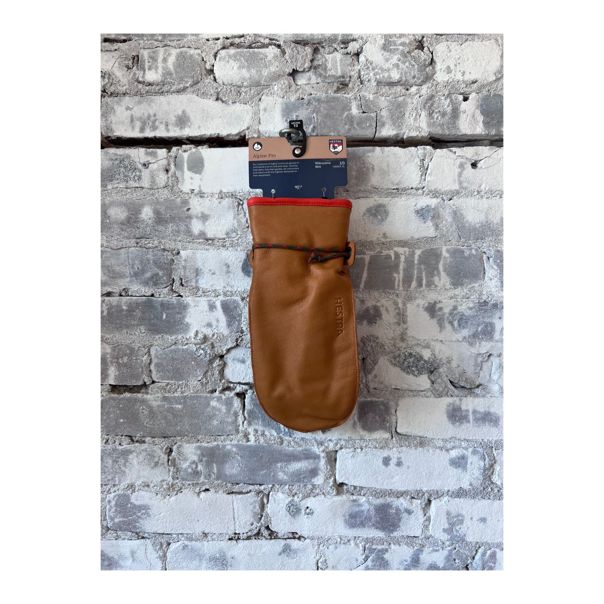 Men's Hestra Wakayama Mitt in cork and brown leather, showing the textured exterior and cozy interior lining.