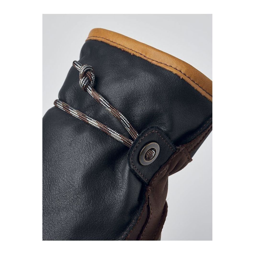 Men's Hestra Wakayama Mitt in navy and brown, showing the warm, insulated leather glove with detailed stitching and soft lining.
