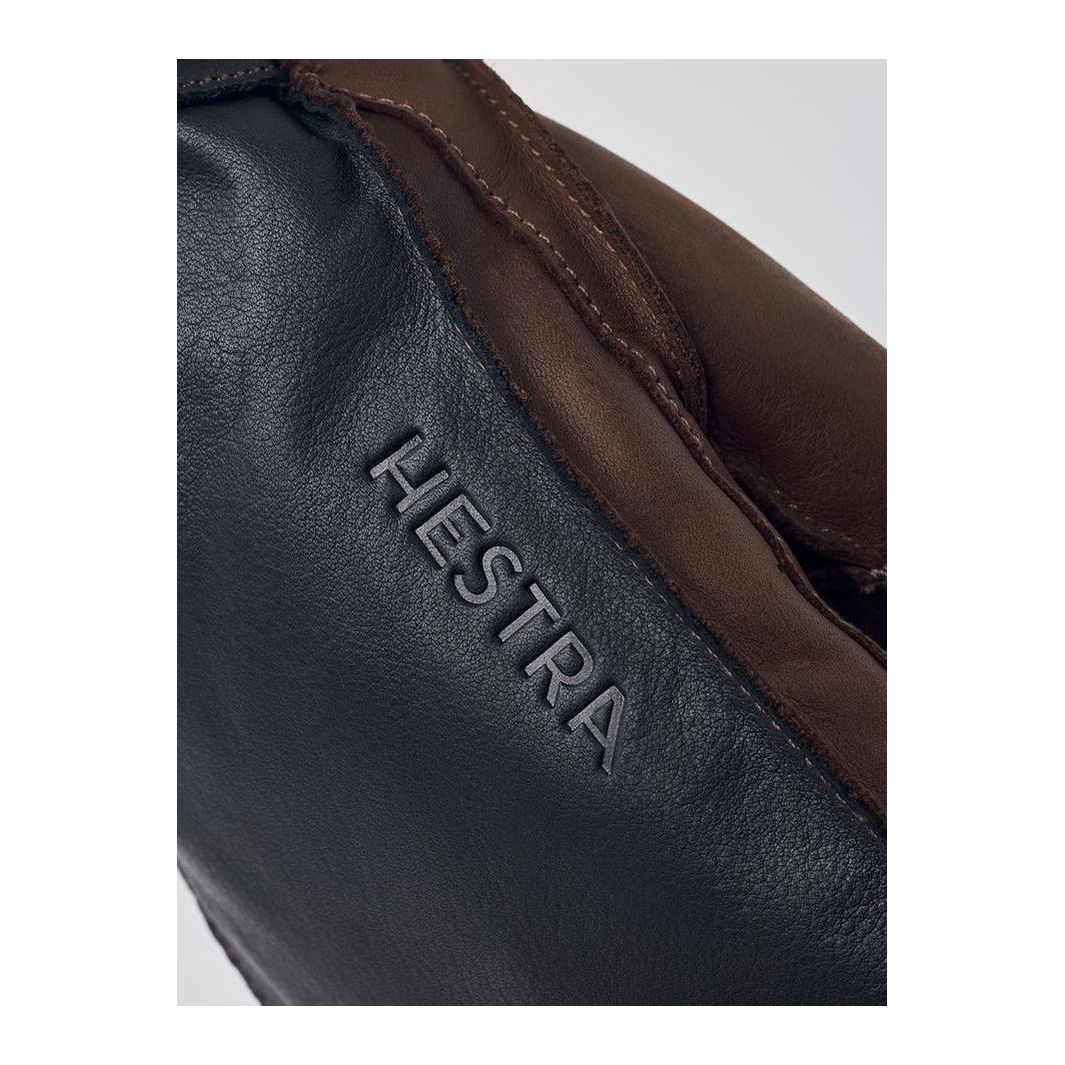 Men's Hestra Wakayama Mitt in navy and brown, showcasing durable leather exterior and comfortable lining for cold weather.