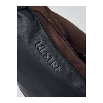 Men's Hestra Wakayama Mitt in navy and brown, showcasing durable leather exterior and comfortable lining for cold weather.