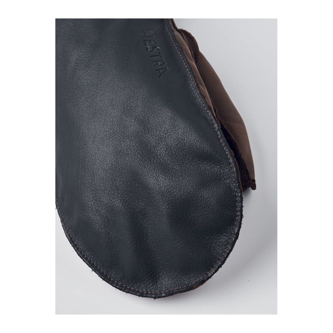Men's Hestra Wakayama Mitt in navy and brown leather with warm lining, designed for outdoor winter protection.