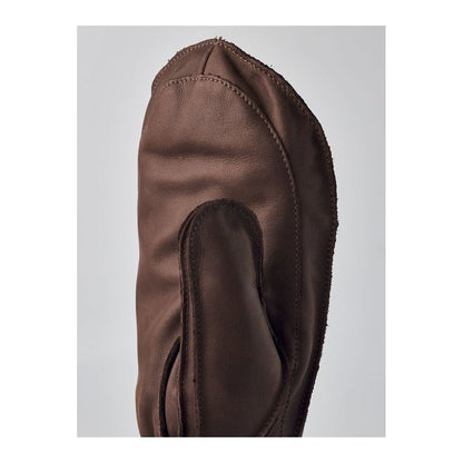 Men's Hestra Wakayama Mitt in navy and brown leather, showing the insulated, durable glove with detailed stitching and wrist closure.