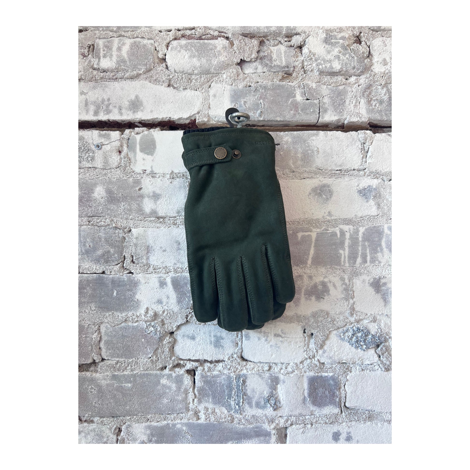 Men's Bergvik Glove in bottle green by Hestra, showing the insulated winter glove with textured exterior and adjustable wrist strap.