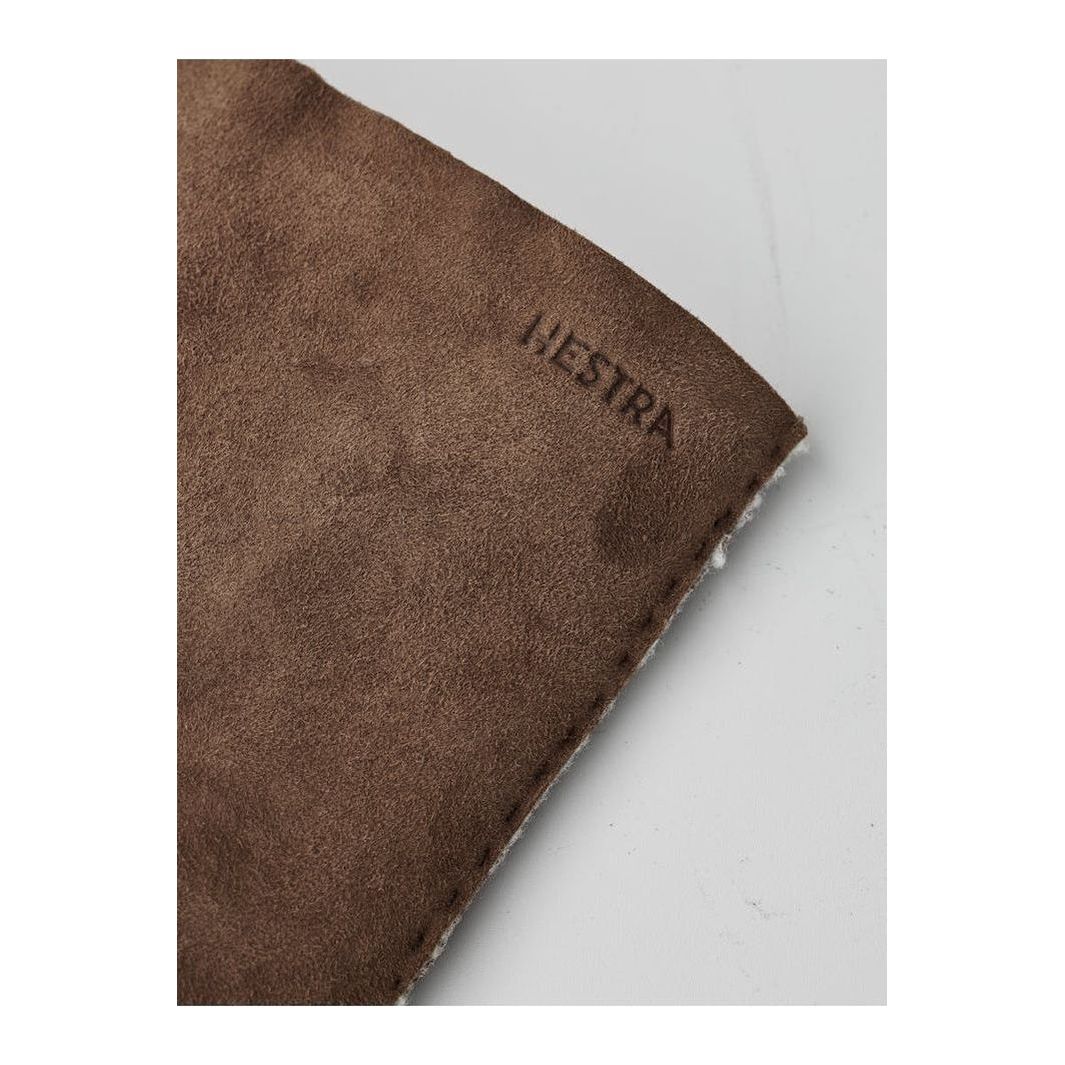 Men's Hestra Bernard Glove in brown leather, showing detailed stitching and soft lining for warmth and comfort.
