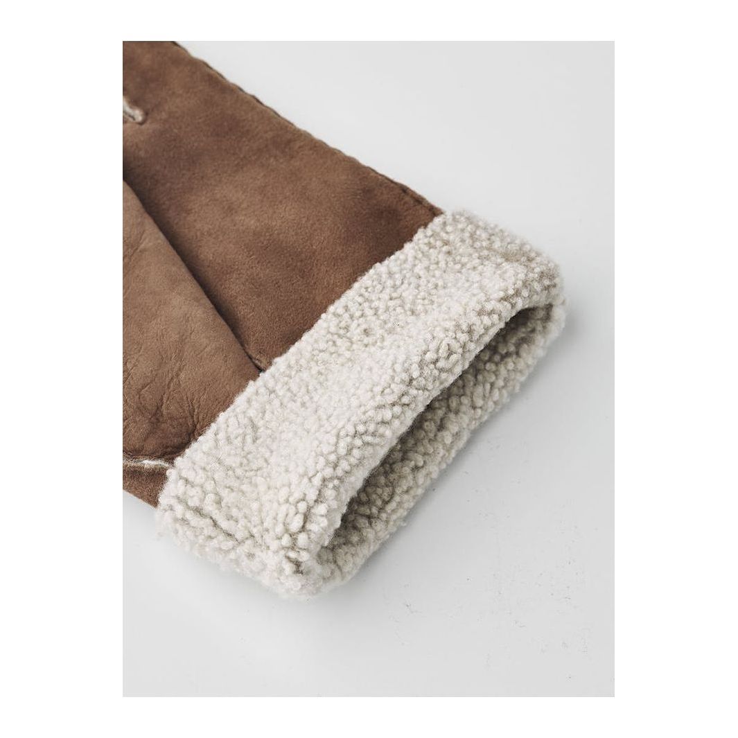 Men's Hestra Bernard Glove in brown leather with soft lining, designed for warmth and comfort during cold weather.