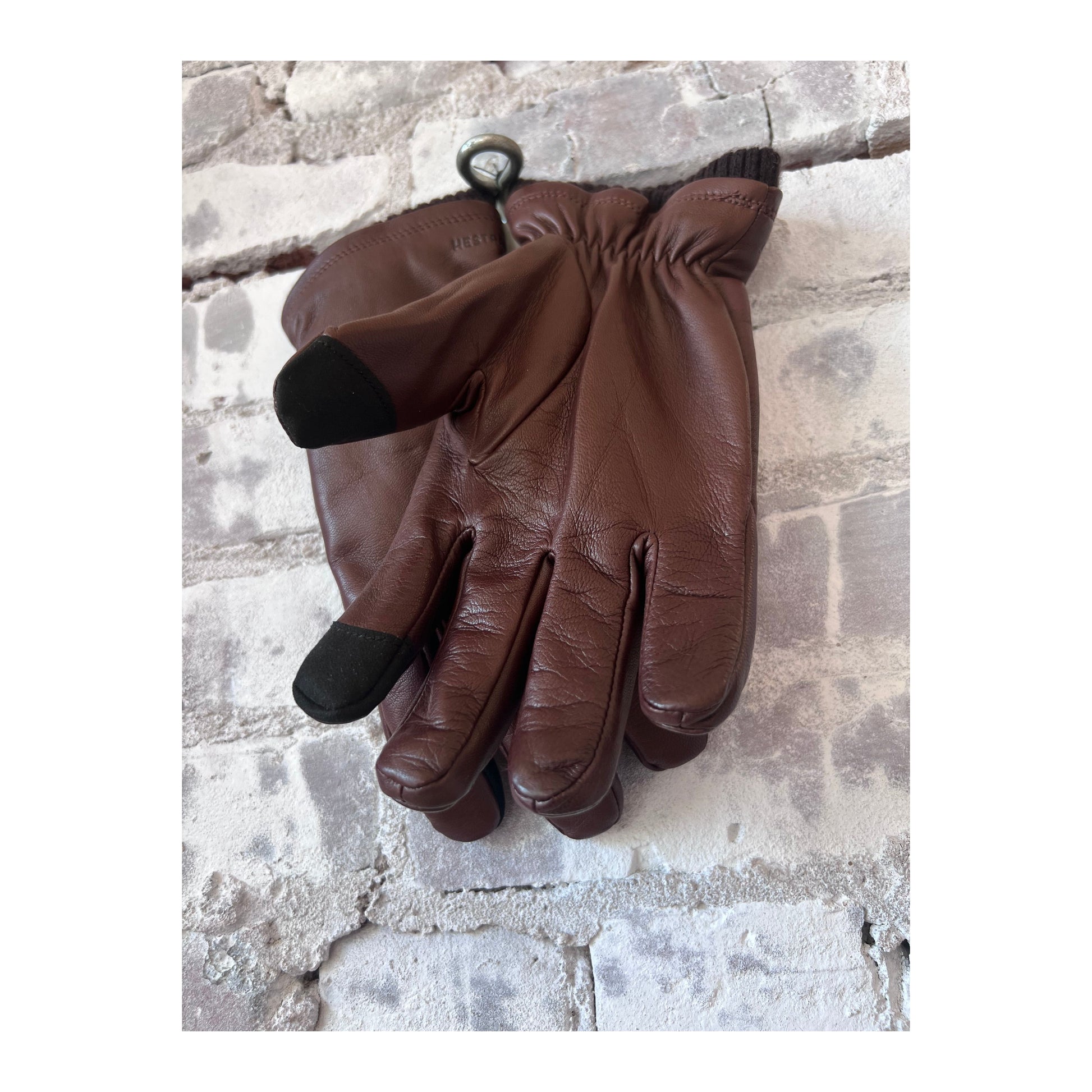 Hestra John men's brown leather gloves with detailed stitching and comfortable fit, perfect for cold weather.