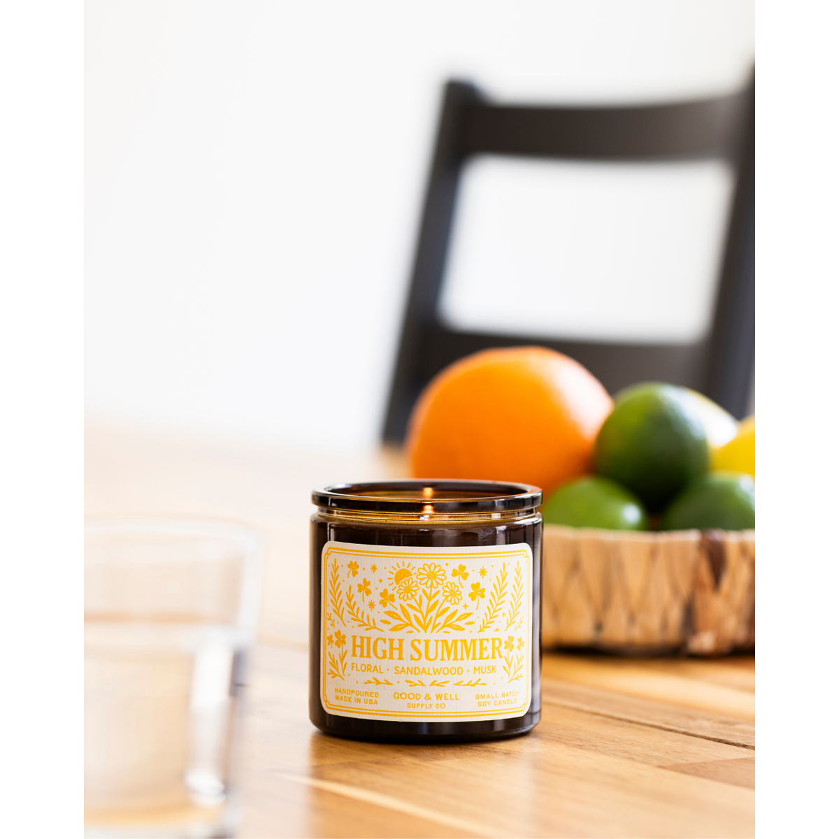 Folk & Flame High Summer Soy Candle by Good & Well Supply Co. in a glass jar, ideal for home decor and summer ambiance.