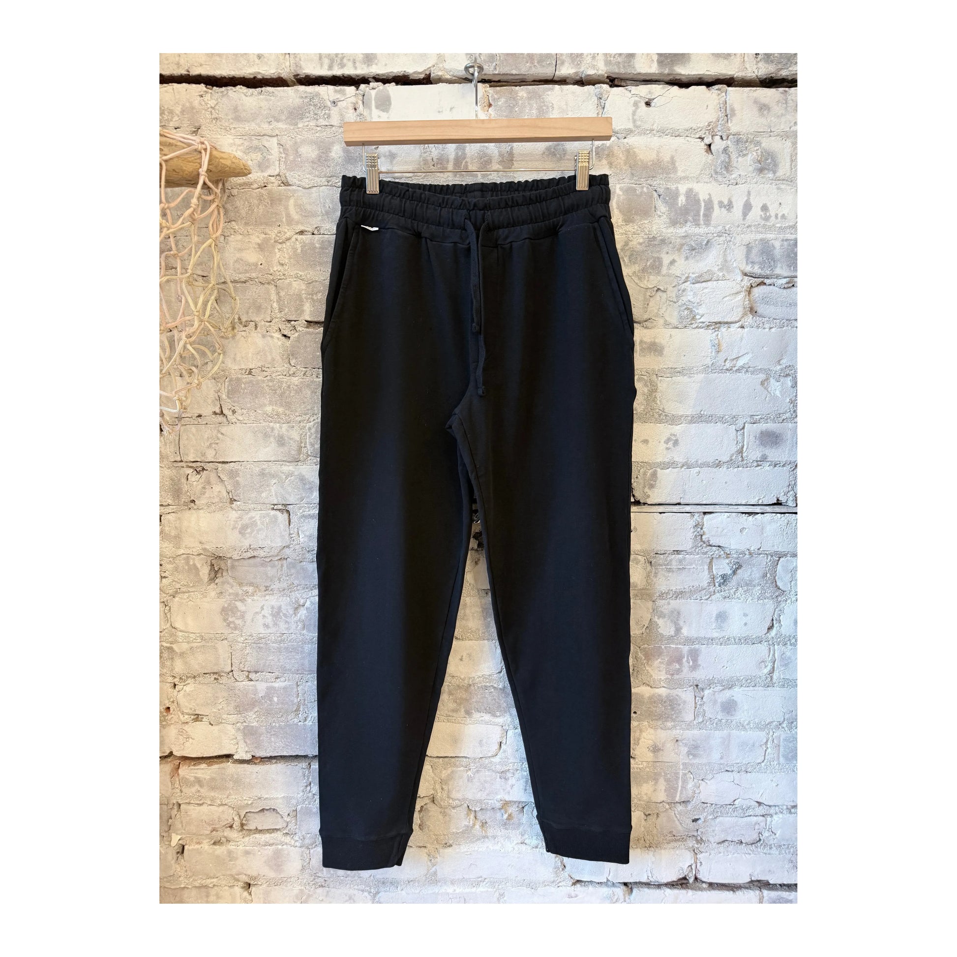 Men's black IF Jogger pants by 04651 with a relaxed fit and elastic waistband, shown in a casual side view.