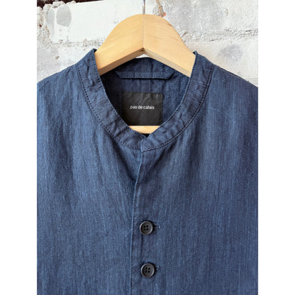 Women's dark indigo linen chambray jacket by Pas de Calais, featuring a relaxed fit and classic collar, displayed on a hanger.