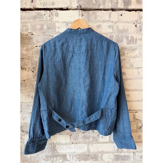 Light indigo women's linen chambray jacket by Pas De Calais, shown on a hanger with a casual, relaxed fit and textured fabric.
