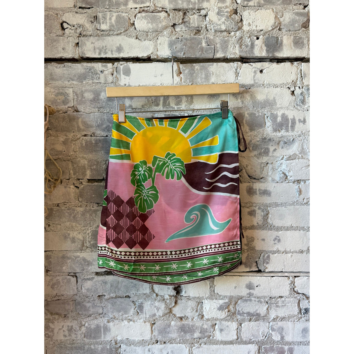 Women's Isla Spell Mini Skirt in Green Multi by Lost + Wander, featuring a vibrant, patterned design on lightweight fabric.