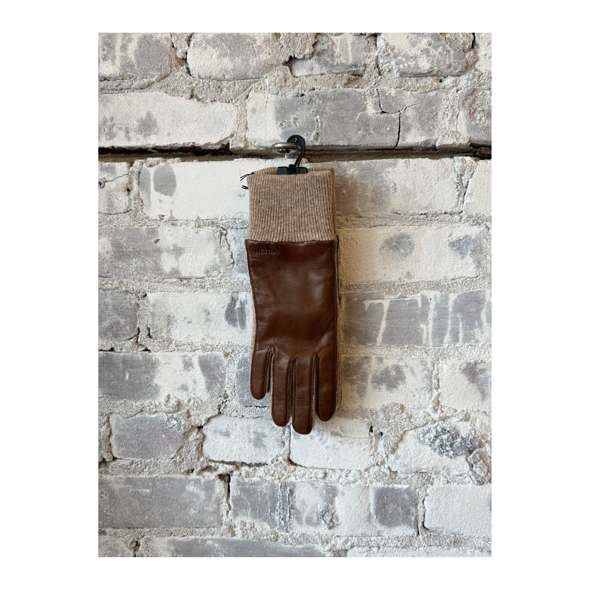 Hestra Jeanne women's light brown gloves made of soft leather, shown with fingers extended and detailed stitching.
