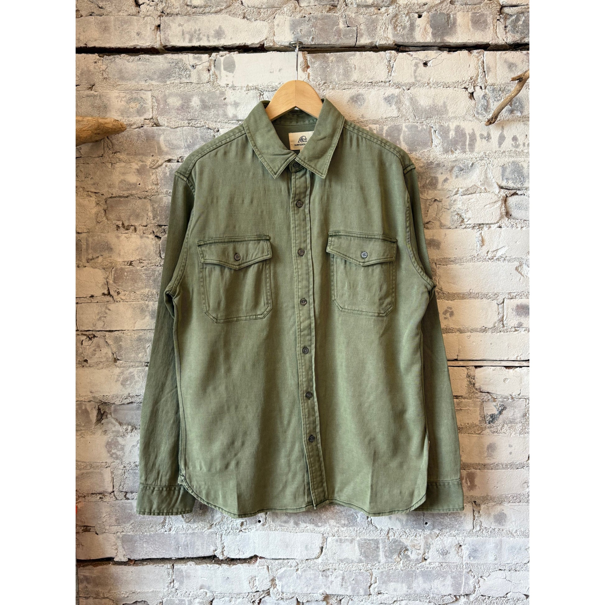 Men's Jeb Tencel Shirt in Deep Lichen Green by Surfside Supply, showing a relaxed fit and soft fabric in a casual setting.