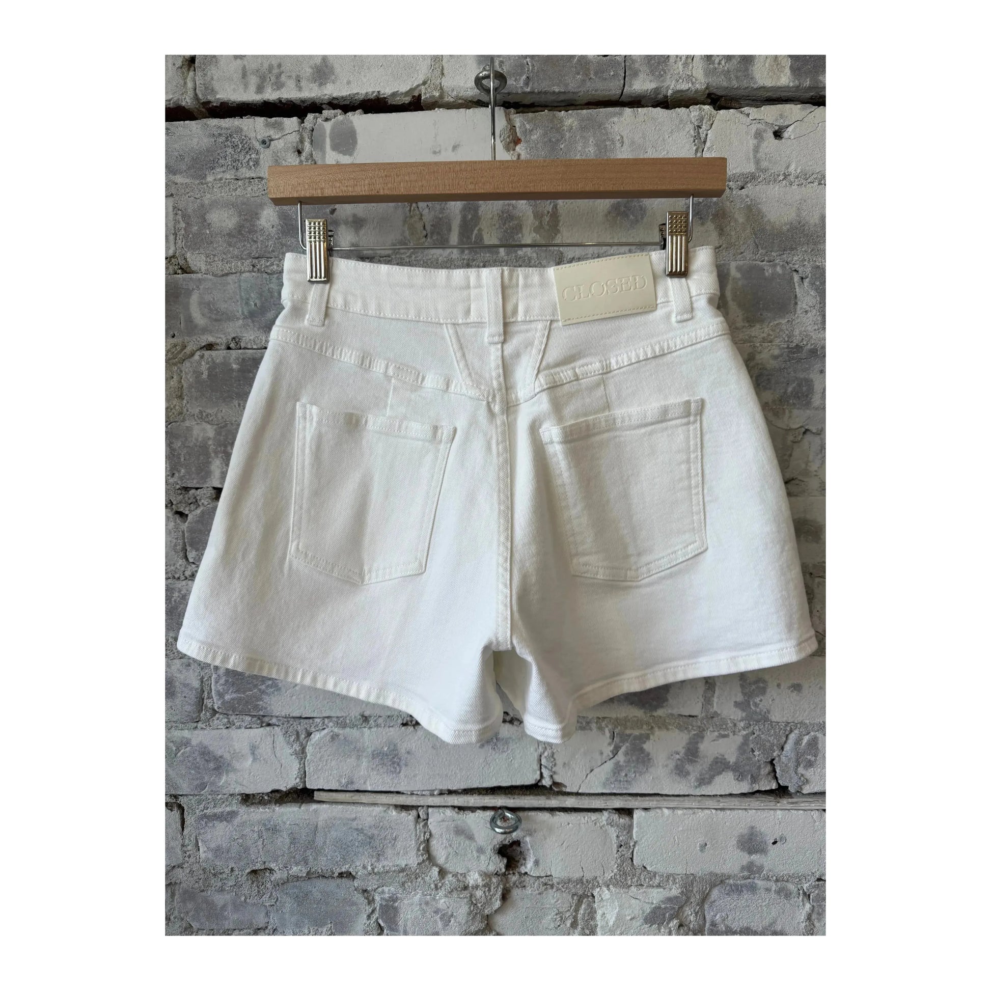 Women's white Jocy-X denim shorts by Closed Women's, showcasing the classic fit and distressed details on a casual style.