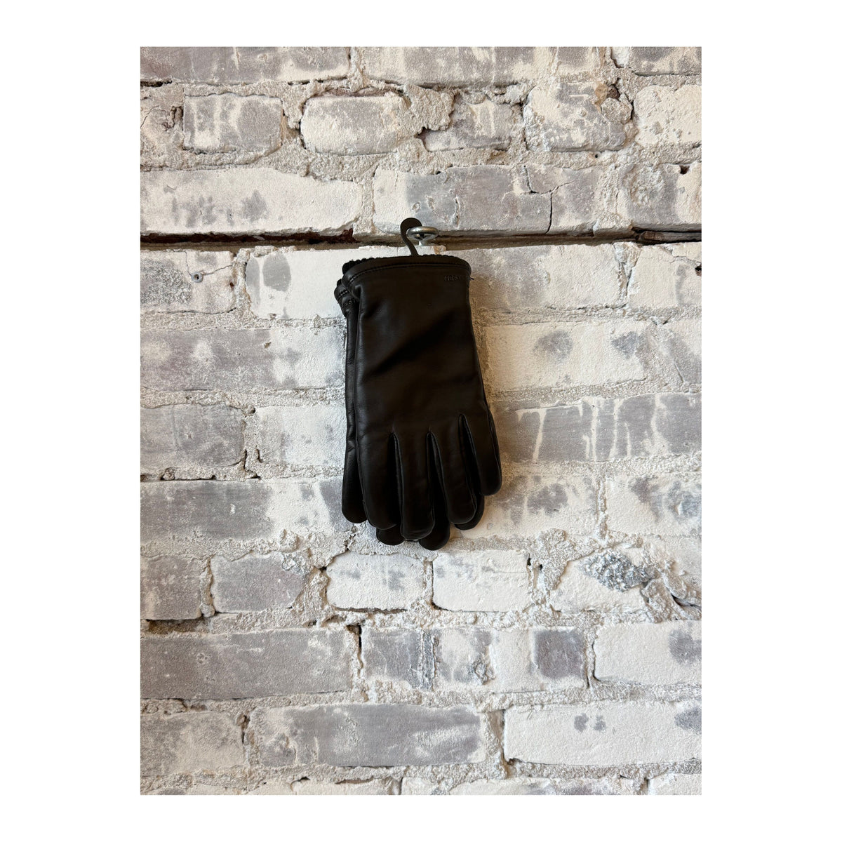 Men's black Hestra John Glove, stylish and warm leather winter glove with detailed stitching and snug fit.