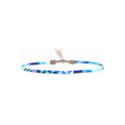 Blue mini bracelet by Julie Rofman featuring delicate jewelry design with small, vibrant blue beads.