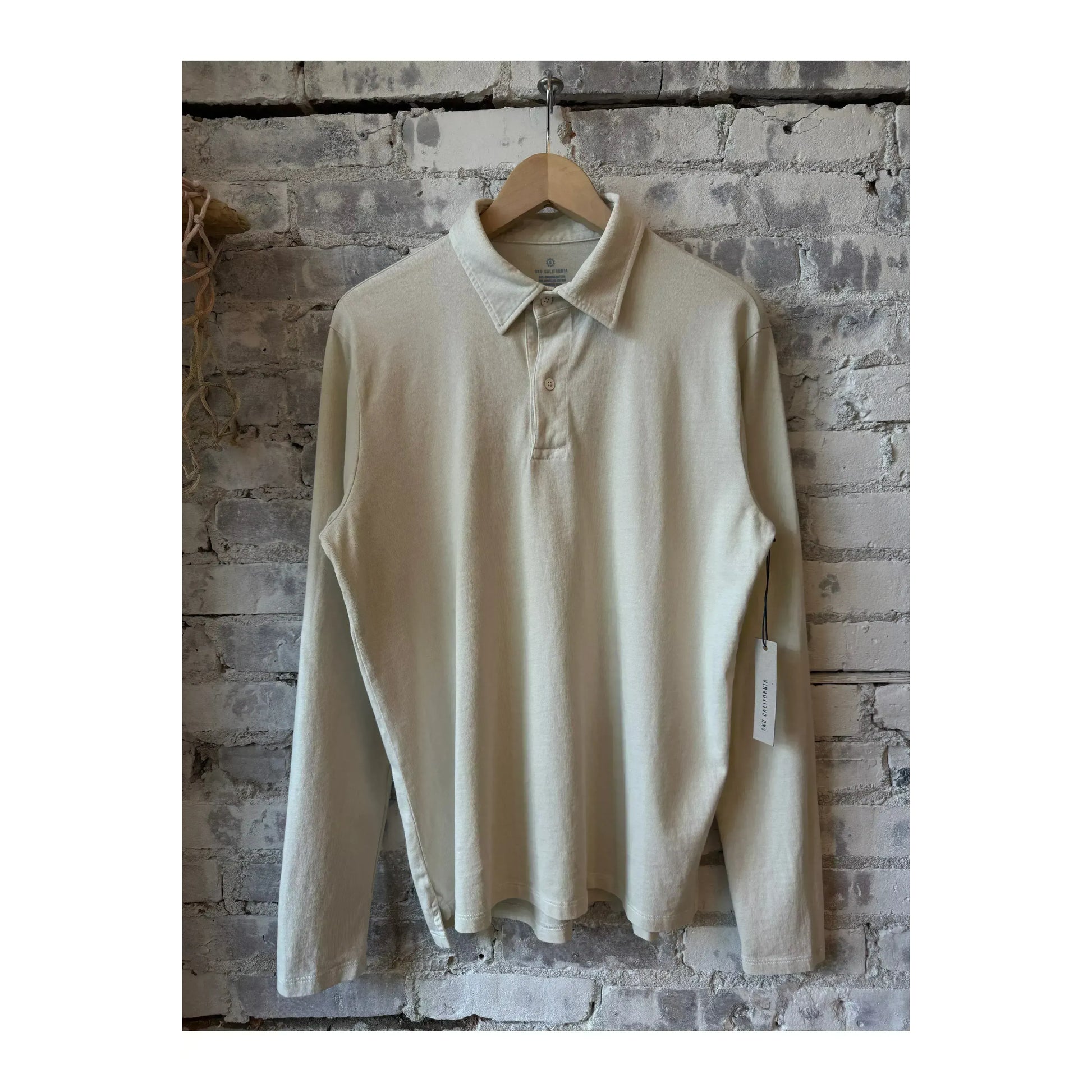 Men's long-sleeve organic recycled polo shirt by Save Khaki United in salt color, featuring a classic collar and button placket.