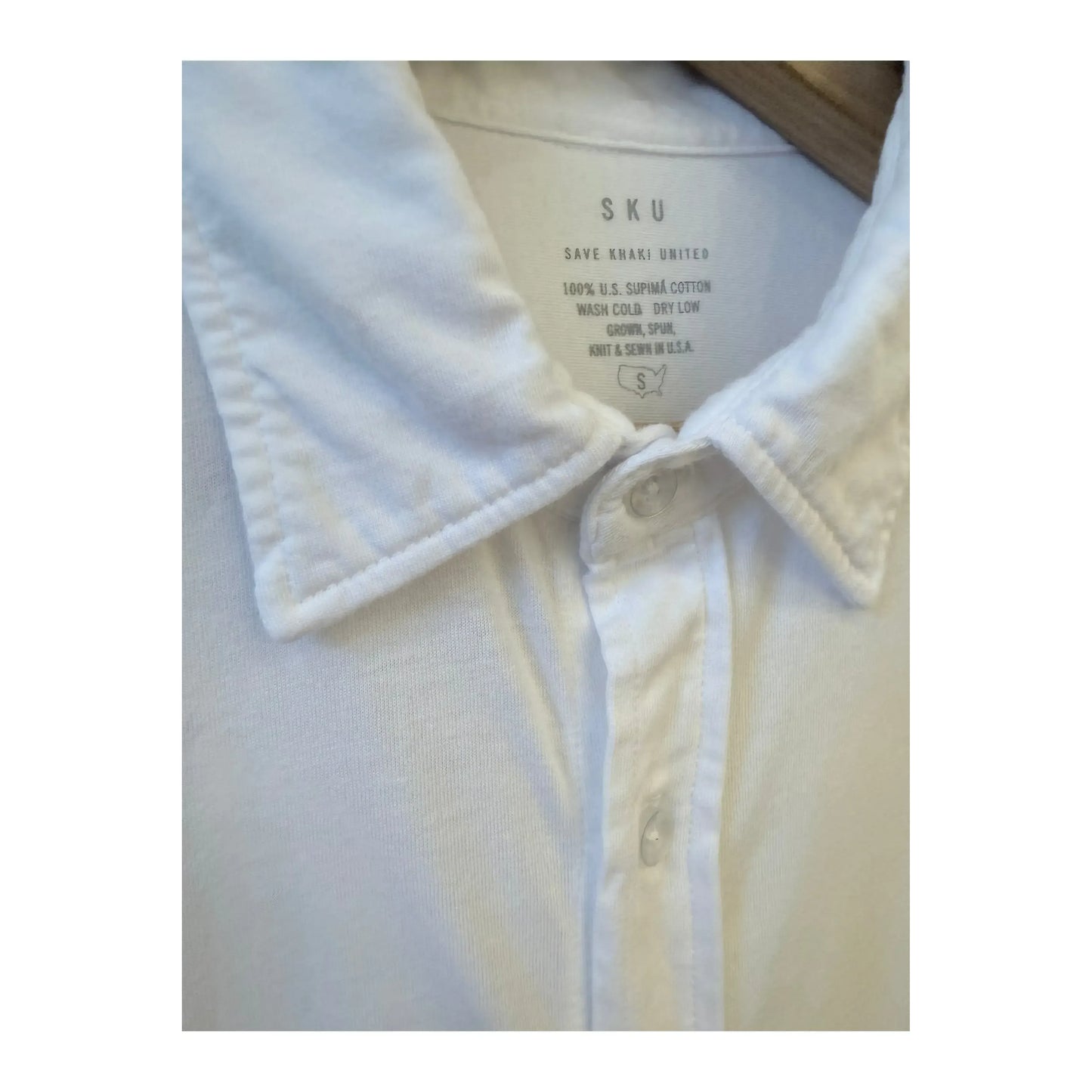Men's white long-sleeve Supima jersey easy shirt by Save Khaki United, shown laid flat with button details.
