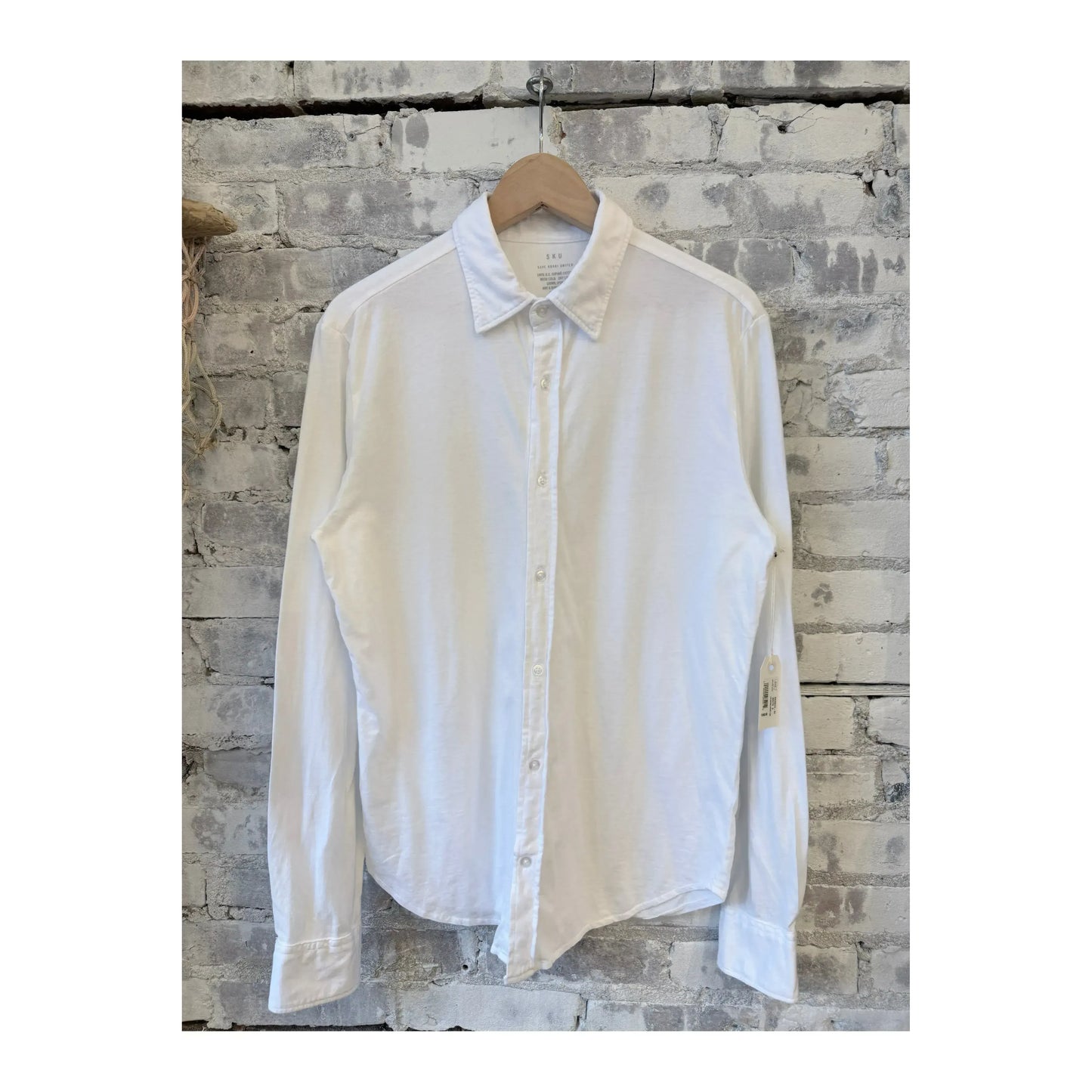 Men's white Save Khaki United long-sleeve Supima jersey easy shirt displayed on a model.