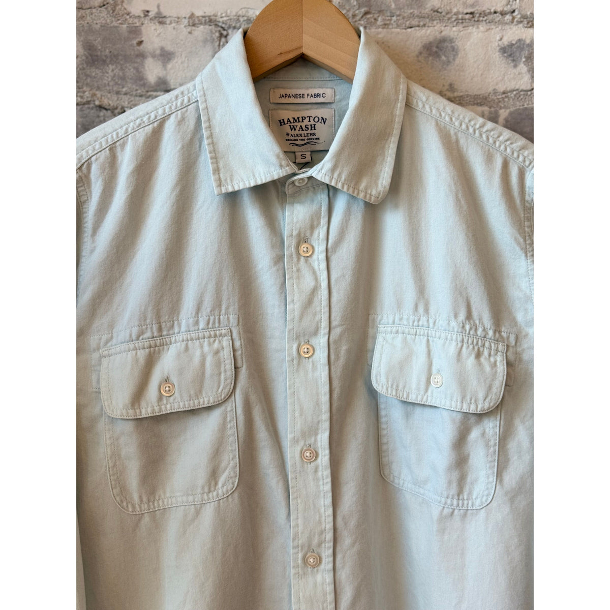 Women's Hampton Wash Laguna Chambray Sky shirt with long sleeves and a classic collar, displayed on a hanger.