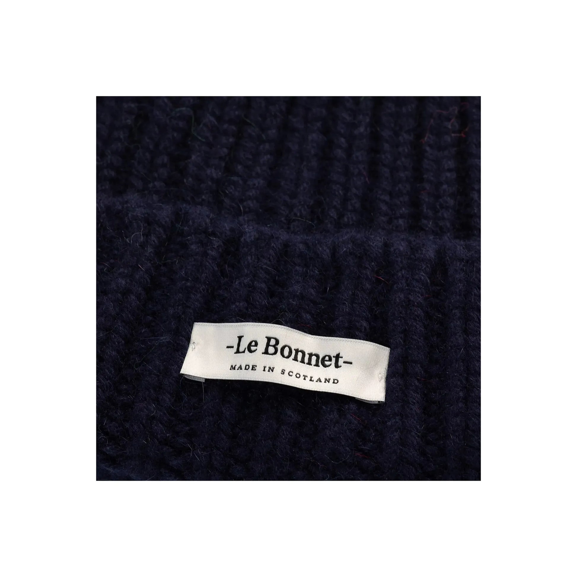 Women's Le Bonnett Logo Beanie in midnight color, close-up of soft knit fabric and embroidered logo detailing.