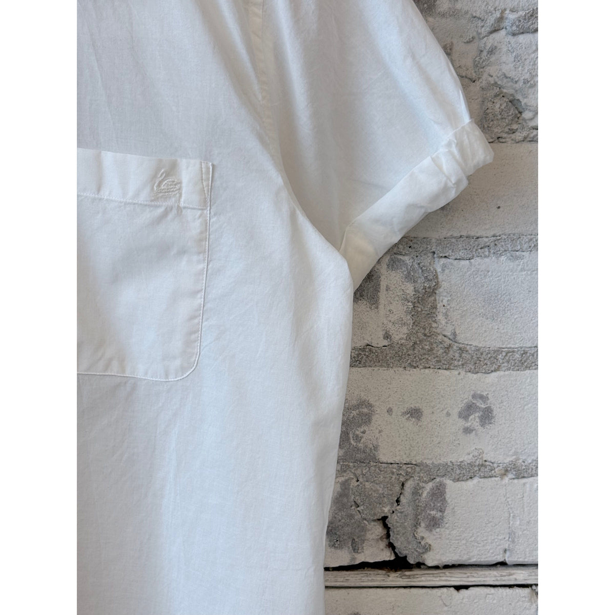 White lightweight cotton poplin women's shirt with rolled-up sleeves by Merz b. Schwanen, shown on a model.