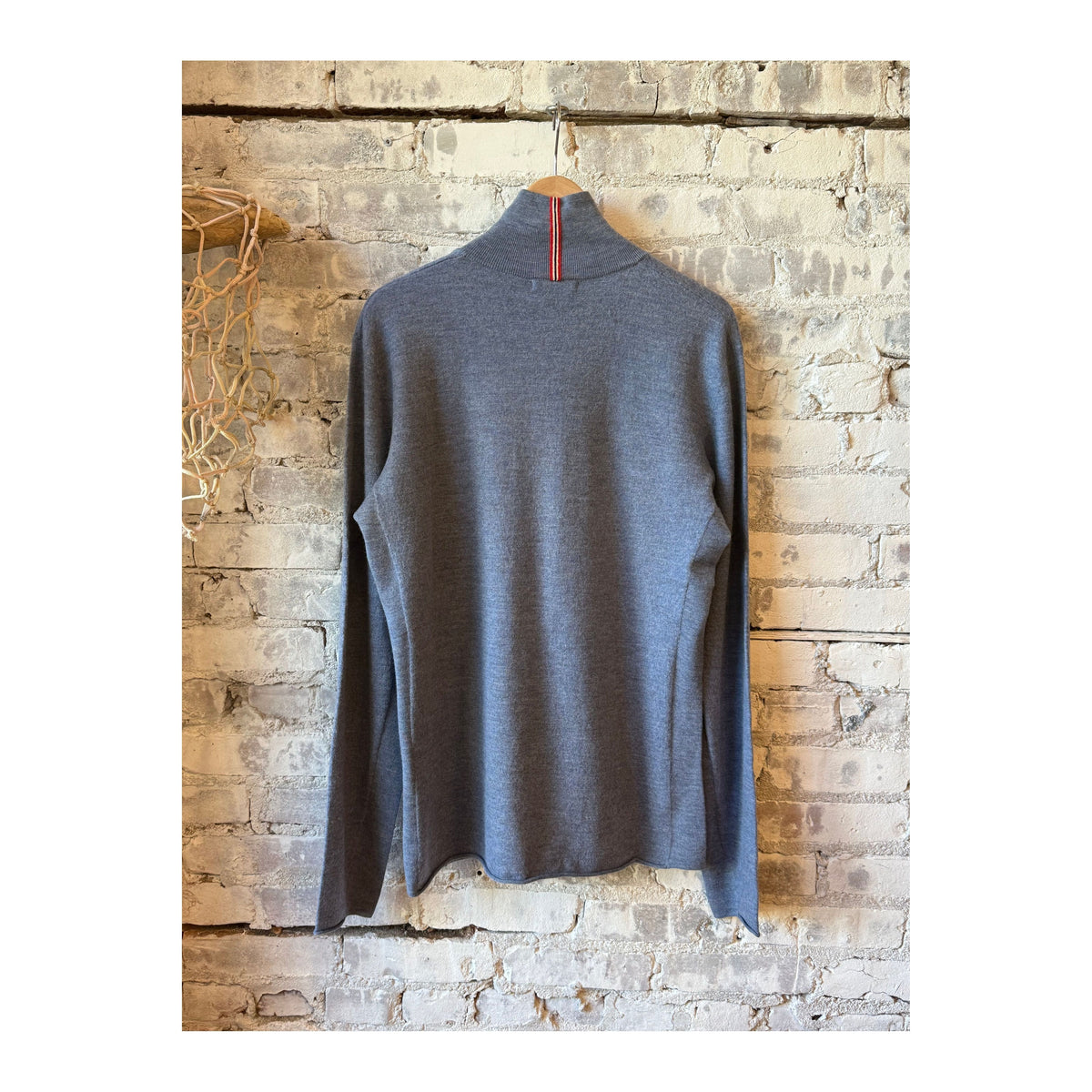 Men's Amundsen boiled denim blue half zip sweater, close-up of fabric and half zip neckline showing textured material and stitching.