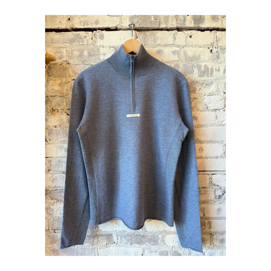 Men's boiled denim blue half zip sweater by Amundsen, featuring a close-up of the textured fabric and half zipper detail.