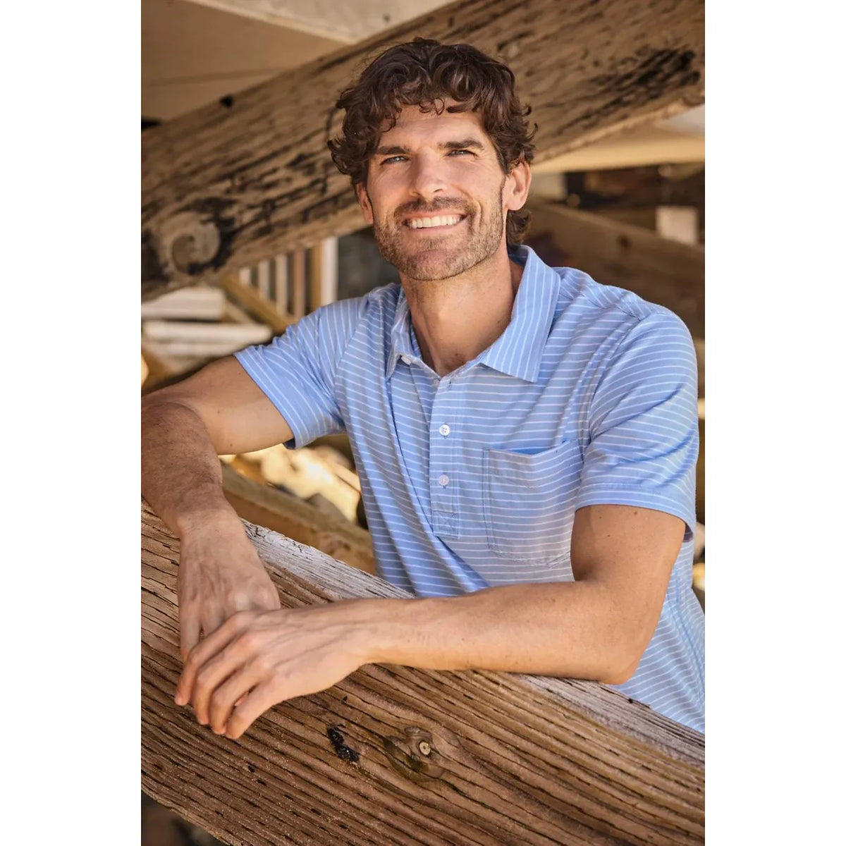 Men's Michael Striped Polo shirt in blue by Surfside Supply, featuring a classic striped pattern and collared design.