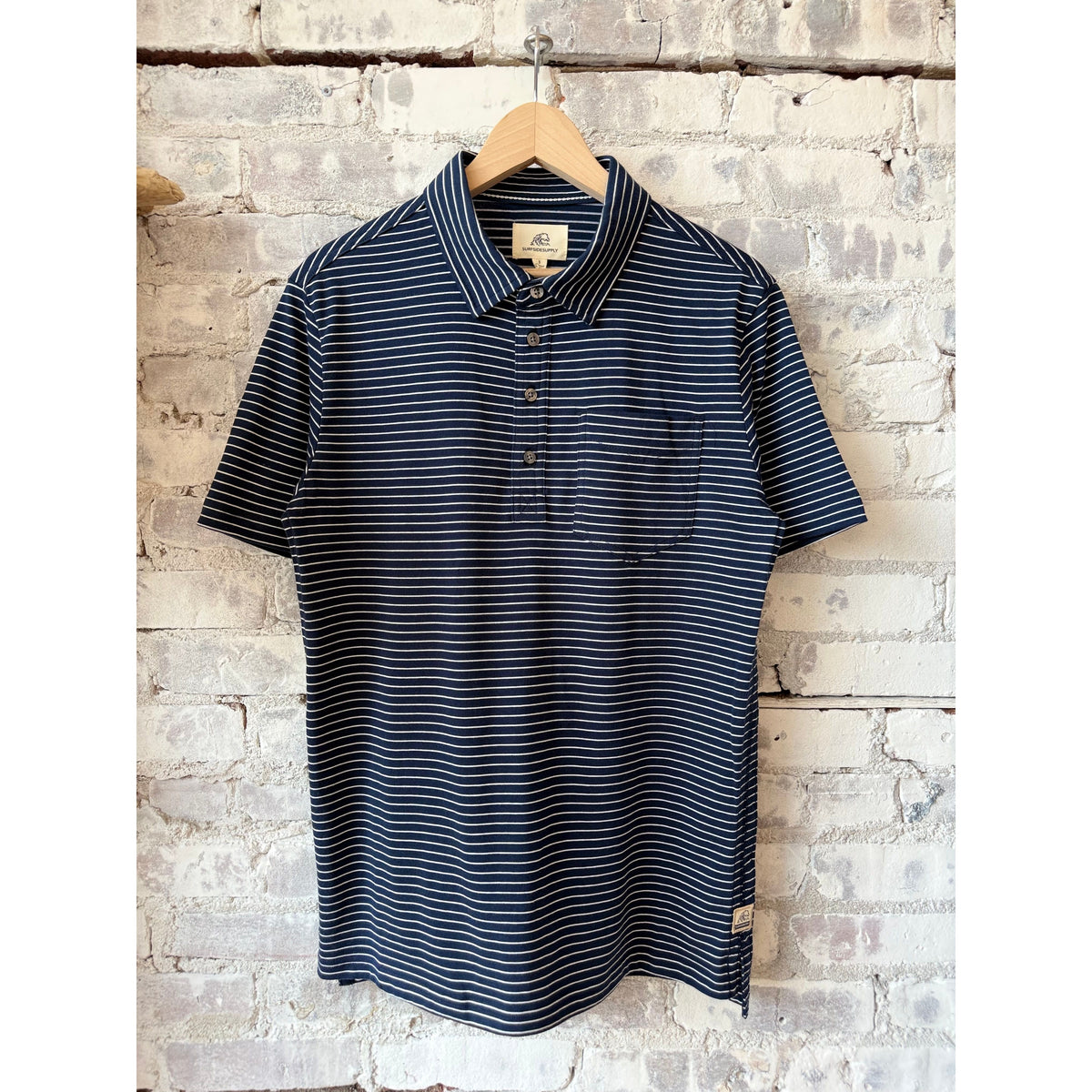 Men's Michael Striped Polo shirt in navy and white from Surfside Supply, featuring a classic polo collar and striped design.
