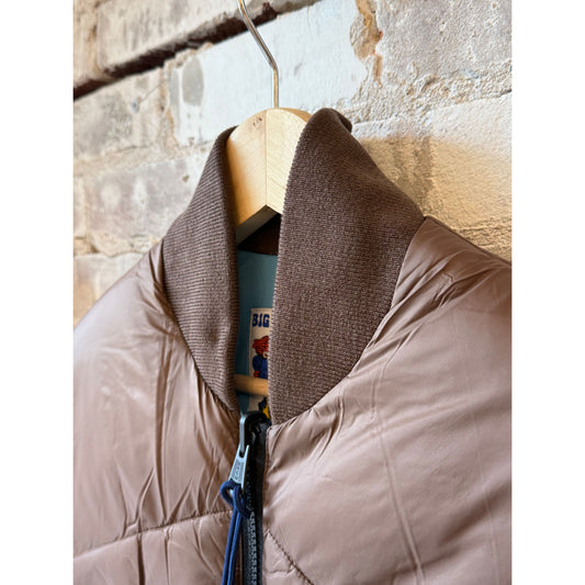 Men's Minarets Vest in Cappuccino by Big Rock Candy Mountaineering, shown in a natural outdoor setting.