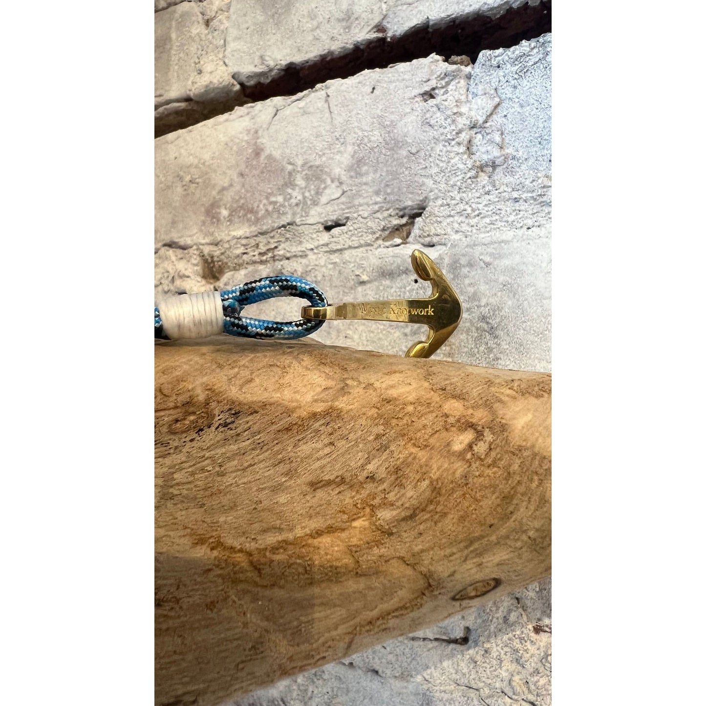 Blue ice nautical brass anchor bracelet from Mystic Knotworks, featuring a detailed anchor charm on a blue cord jewelry piece.