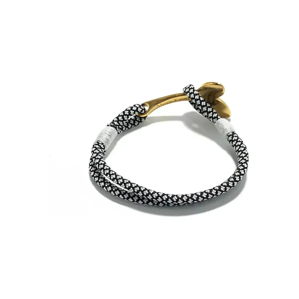 Men's brass bracelet featuring black diamond accents and a nautical whale tail design by Mystic Knotworks.