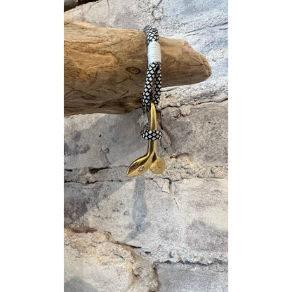 Men's brass Nautical Whale Tail jewelry by Mystic Knotworks, featuring a black diamond design on a detailed whale tail pendant.