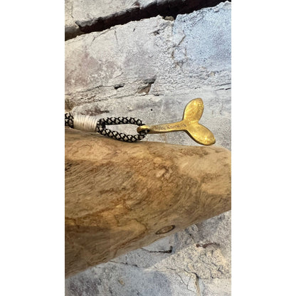 Men's brass whale tail pendant featuring black diamond accents, crafted by Mystic Knotworks, with nautical design details