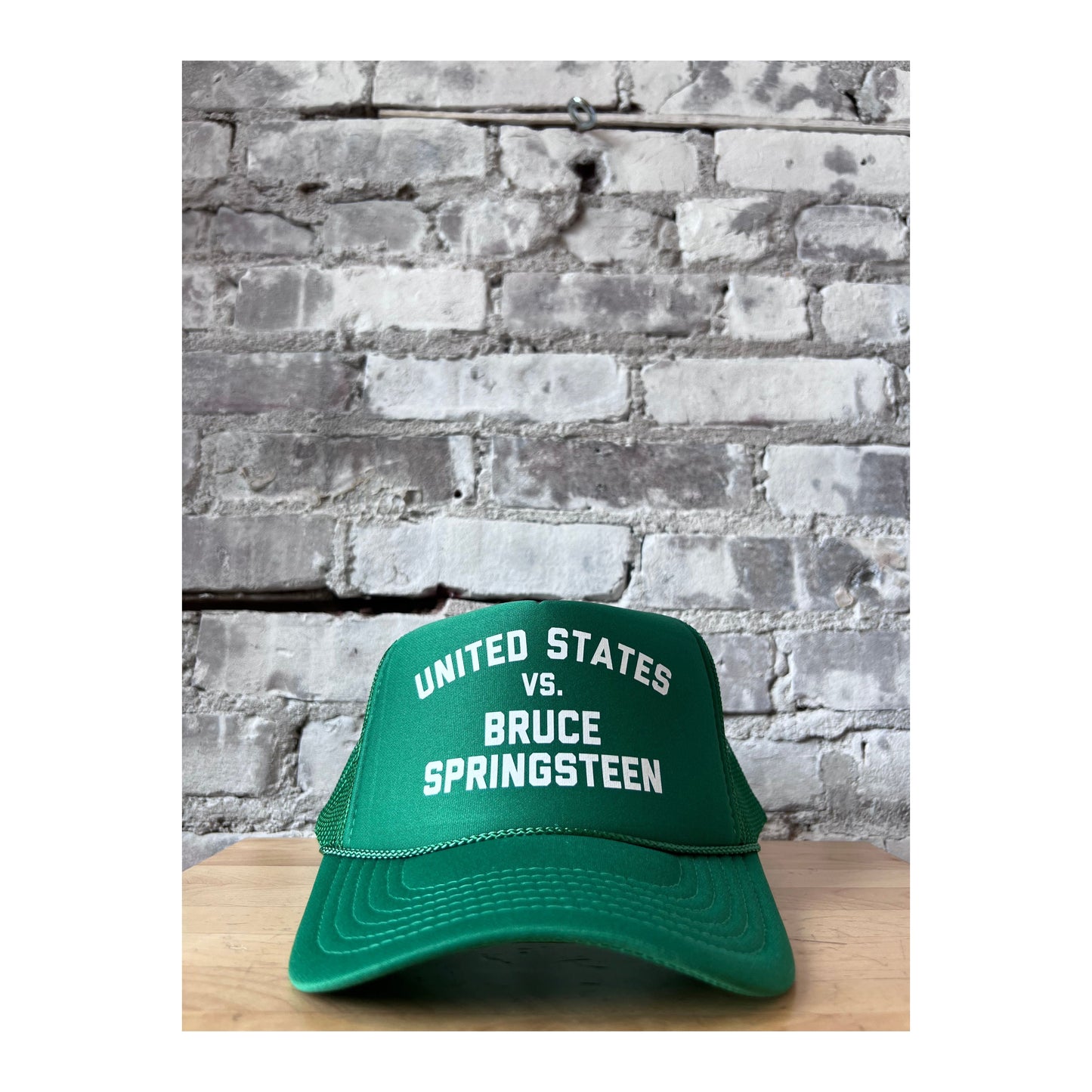 United States vs. Bruce Springsteen trucker hat by N.B. GOODS with Kelly green and white design, casual accessories for fans.