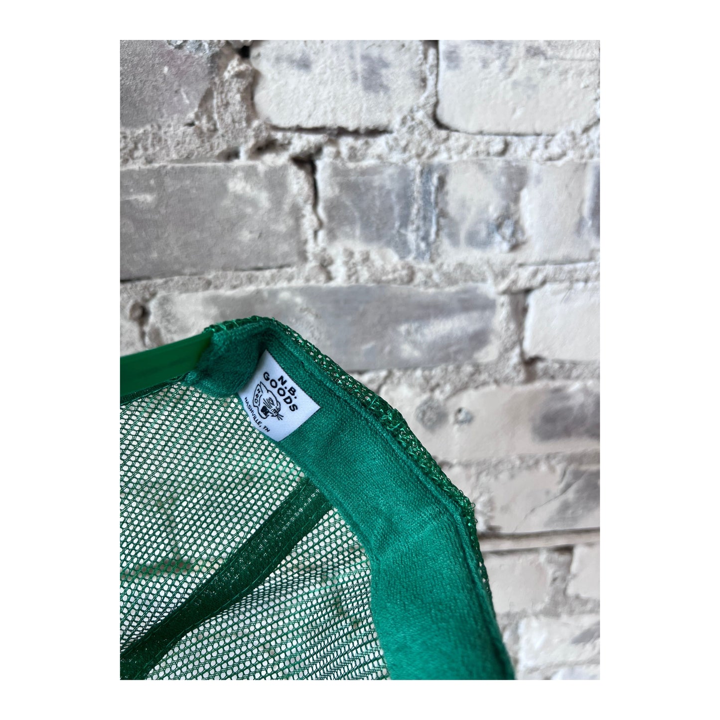 United States vs. Bruce Springsteen trucker hat by N.B. GOODS in Kelly green and white, featuring bold embroidered design.