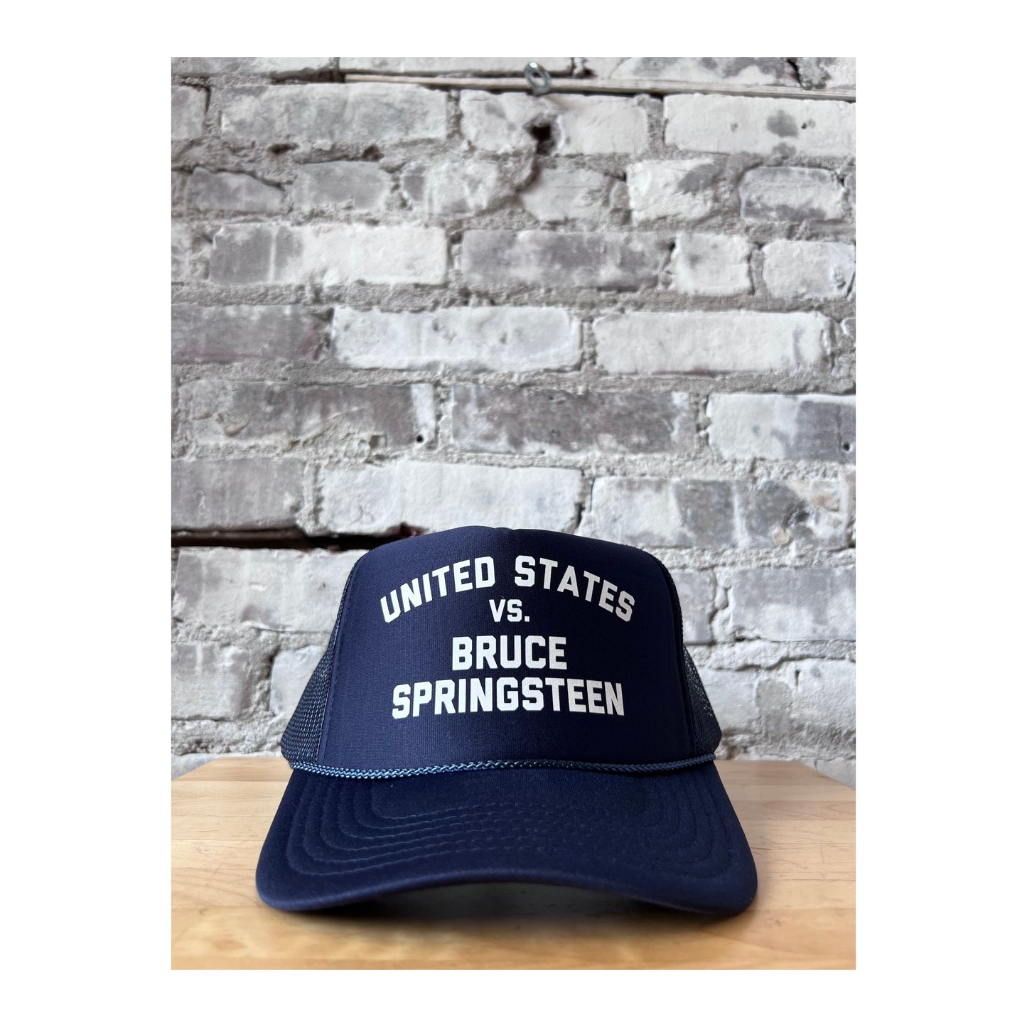 Men's navy and white trucker hat featuring United States vs. Bruce Springsteen design by N.B. GOODS
