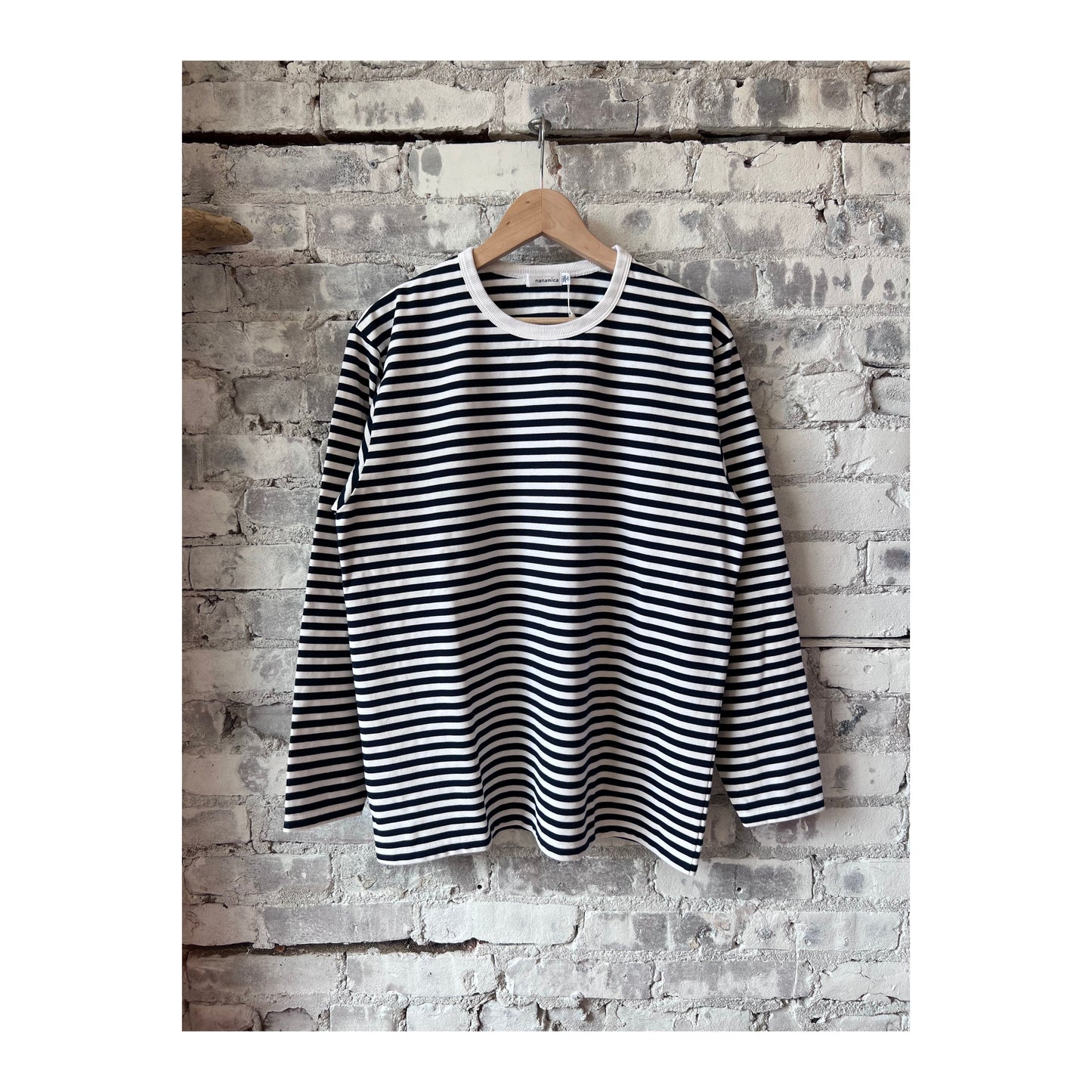 Men's navy and white COOLMAX Stripe Jersey long-sleeve T-shirt by nanamica, featuring a comfortable, breathable fabric and striped design.