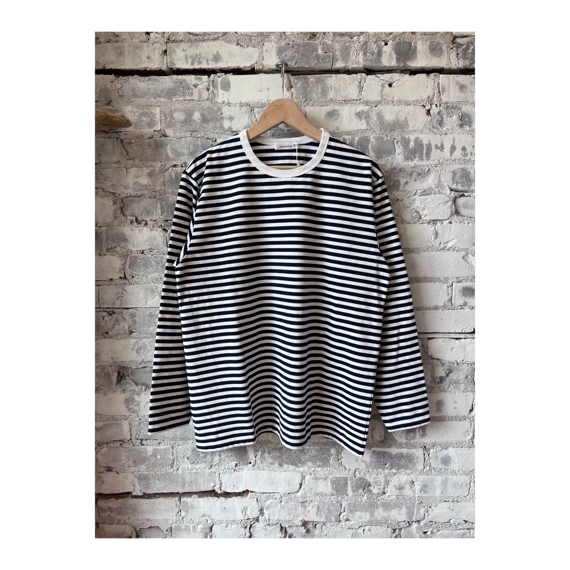 Men's navy and white COOLMAX Stripe Jersey long-sleeve T-shirt by nanamica, featuring a comfortable, breathable fabric and striped design.