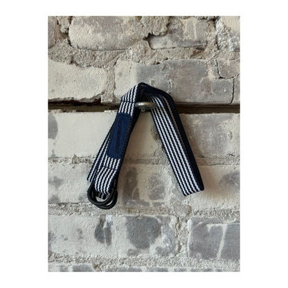 Men's navy stripe tech belt by nanamica featuring a sleek, modern design with adjustable strap and metal buckle.