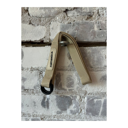 Men's beige tech belt by nanamica featuring a sleek, durable design with adjustable strap and matte buckle detail.
