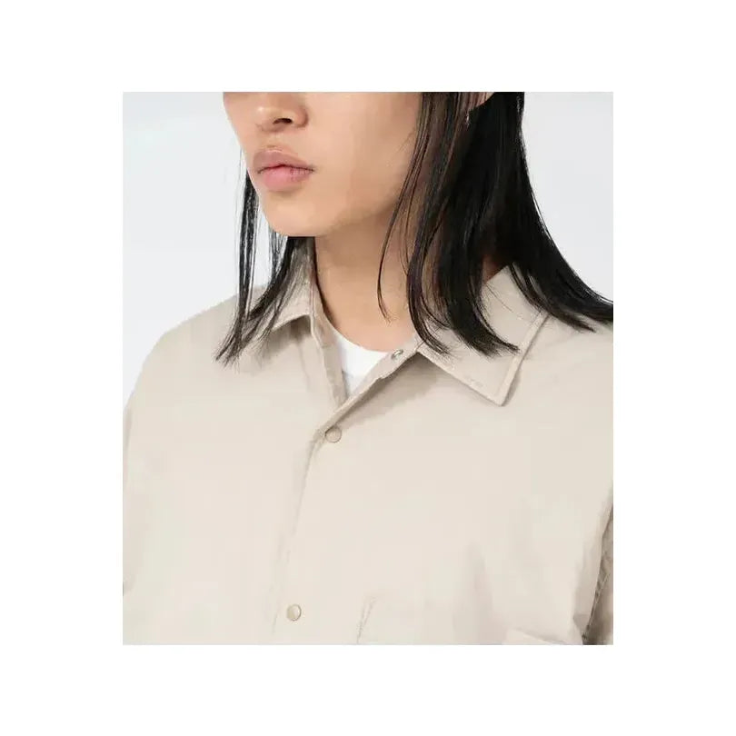 Men's dark navy nanamica insulation shirt jacket, lightweight with a quilted design, displayed on a hanger against a neutral background.