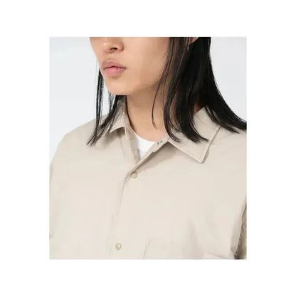 Men's dark navy nanamica insulation shirt jacket, lightweight with a quilted design, displayed on a hanger against a neutral background.