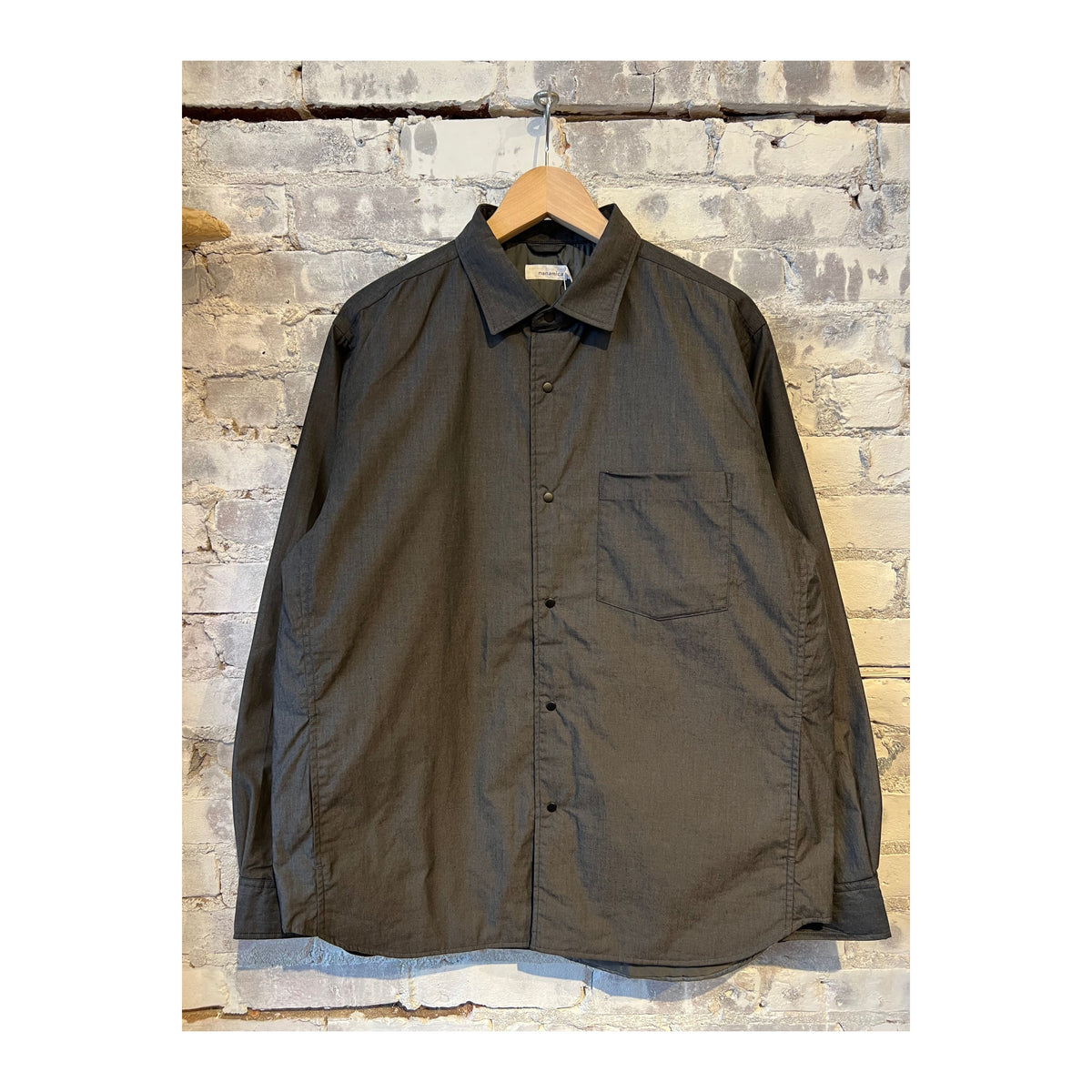 Men's gray nanamica insulation shirt jacket with a stand-up collar and zipper front, designed for layered warmth and outdoor use.