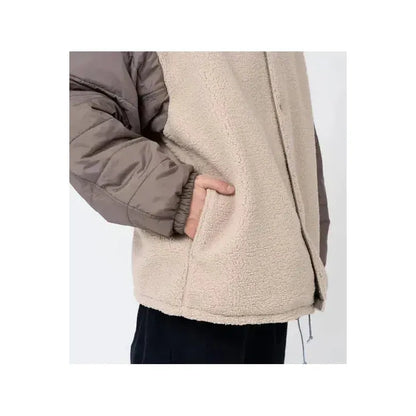 Men's reversible wind jacket in beige by nanamica, showing the outer and inner sides with lightweight, wind-resistant fabric.