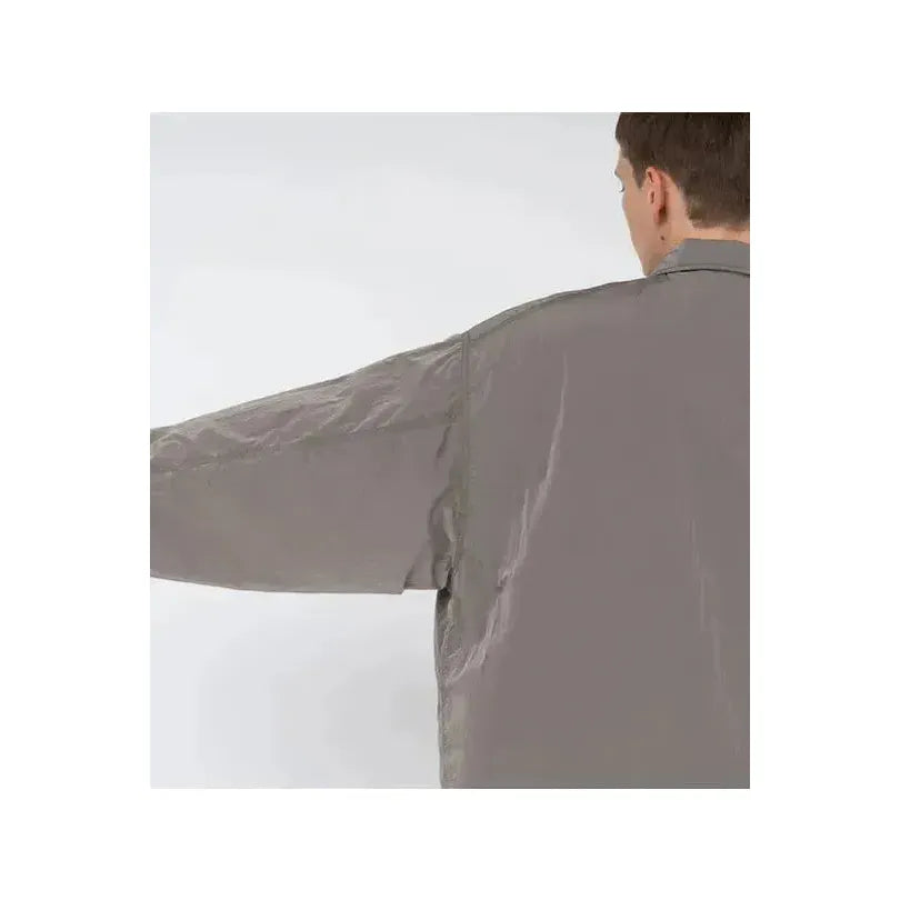 Men's reversible beige wind jacket by nanamica, showing the jacket’s front and back with windproof fabric and adjustable hood.