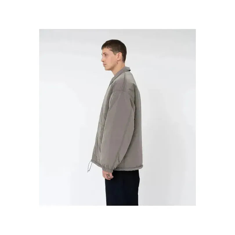 Men's reversible beige wind jacket by nanamica, showing the outer and inner fabric details in the image.